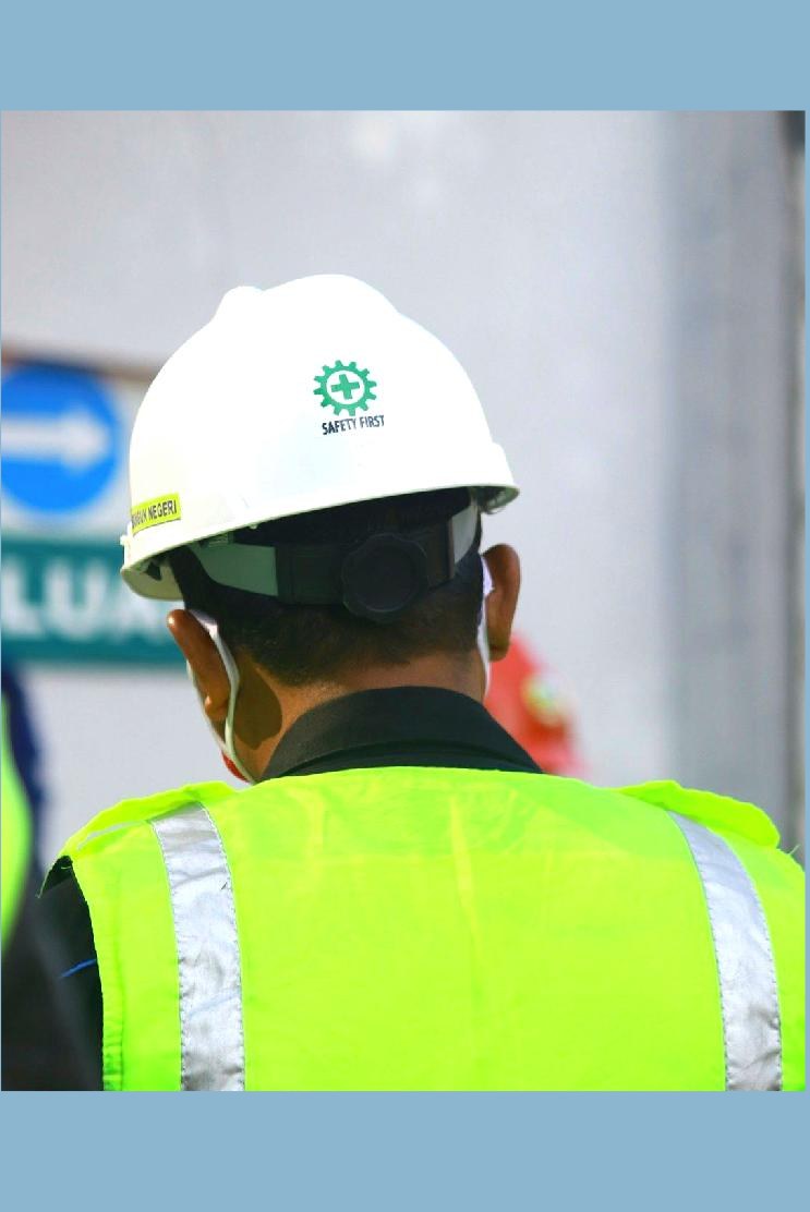 Electrical worker wearing a safety helmet and high visibility vest
